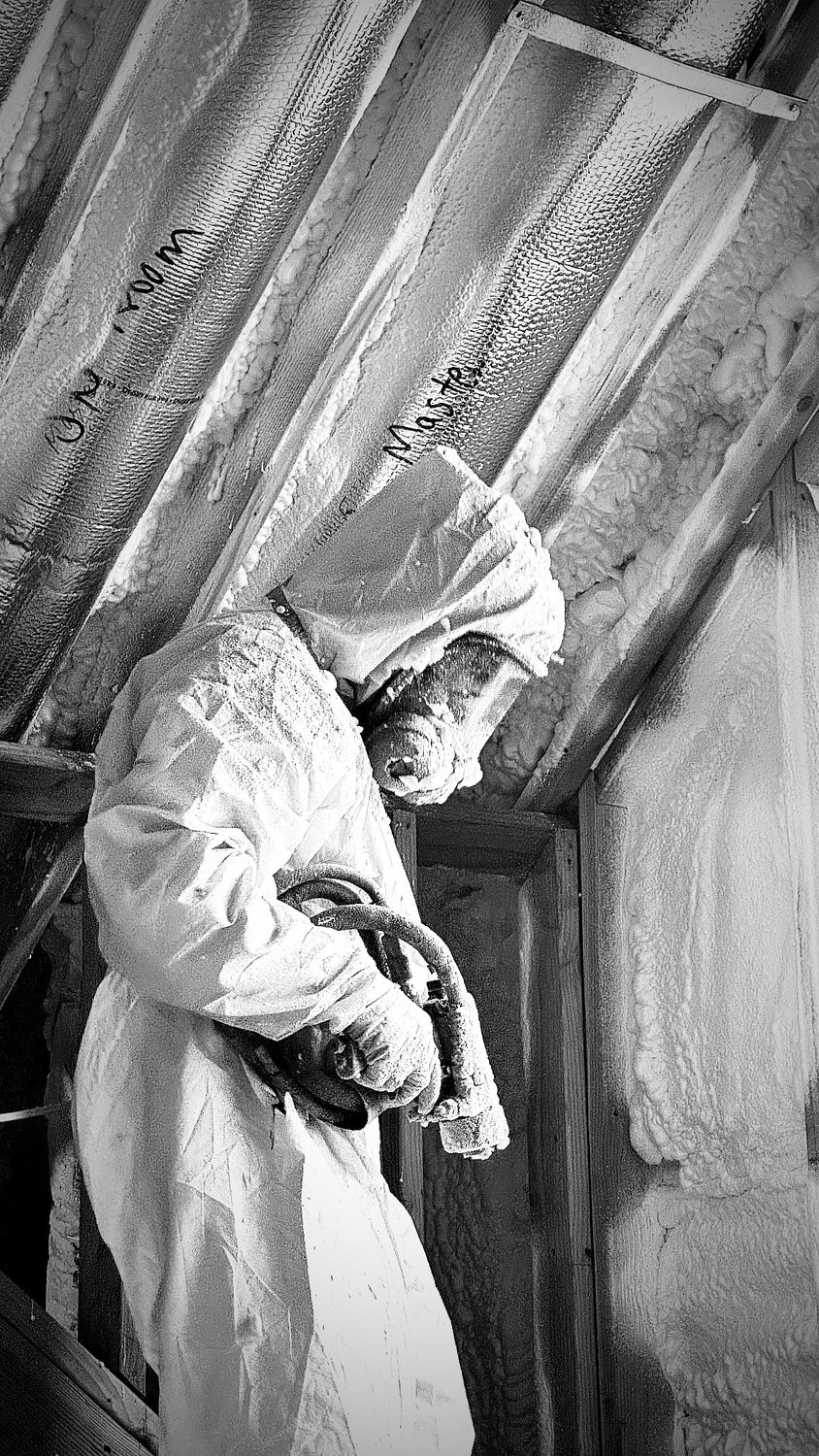 A builder at work on a More Life home, black and white.