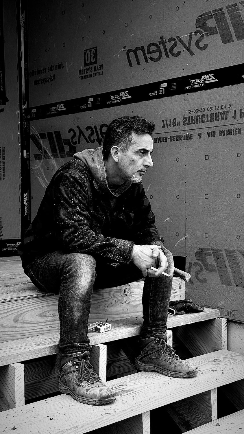 A builder at work on a More Life home, black and white.