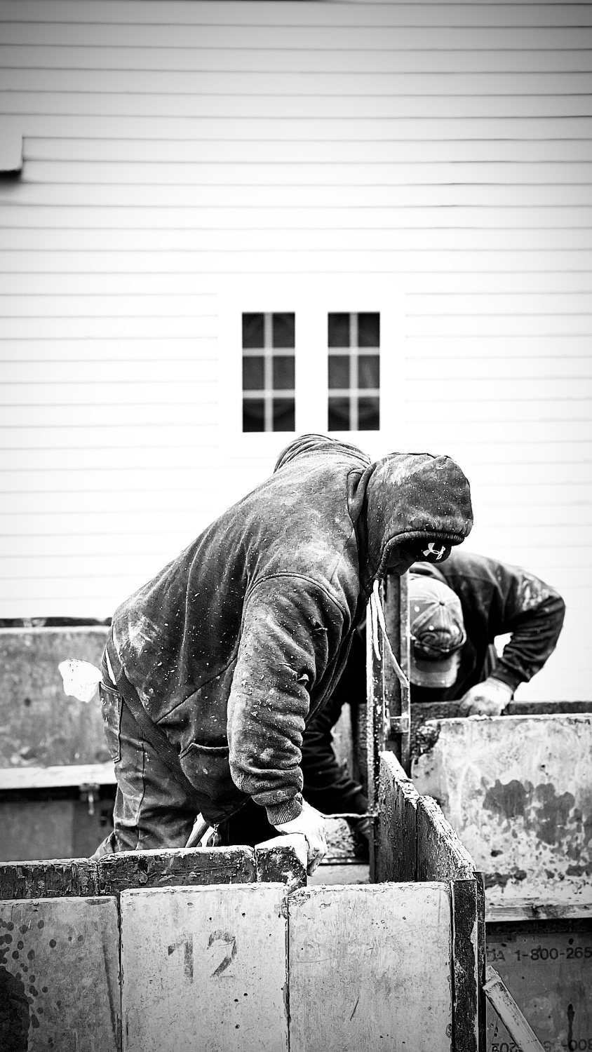 A builder at work on a More Life home, black and white.