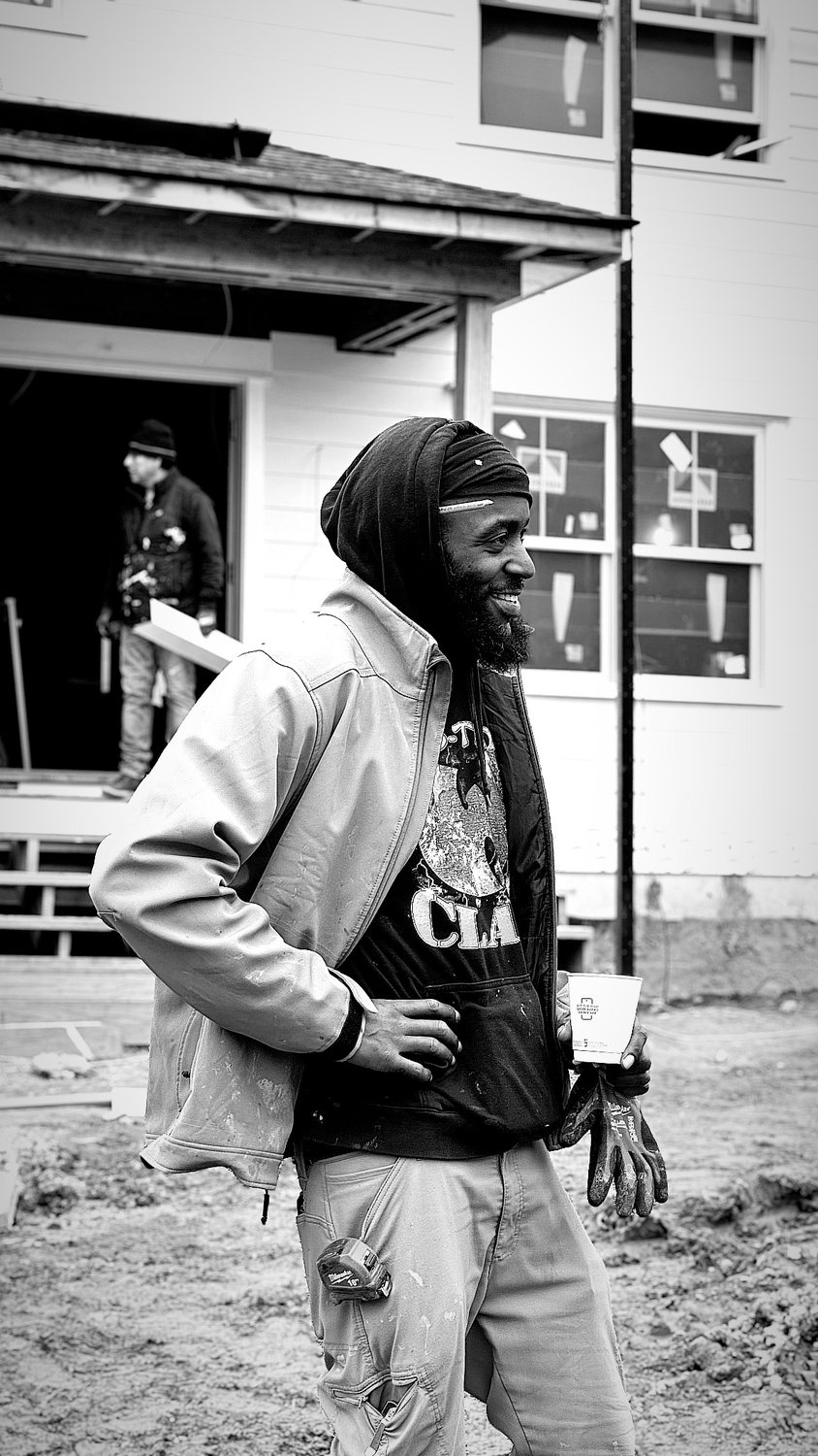 A builder at work on a More Life home, black and white.