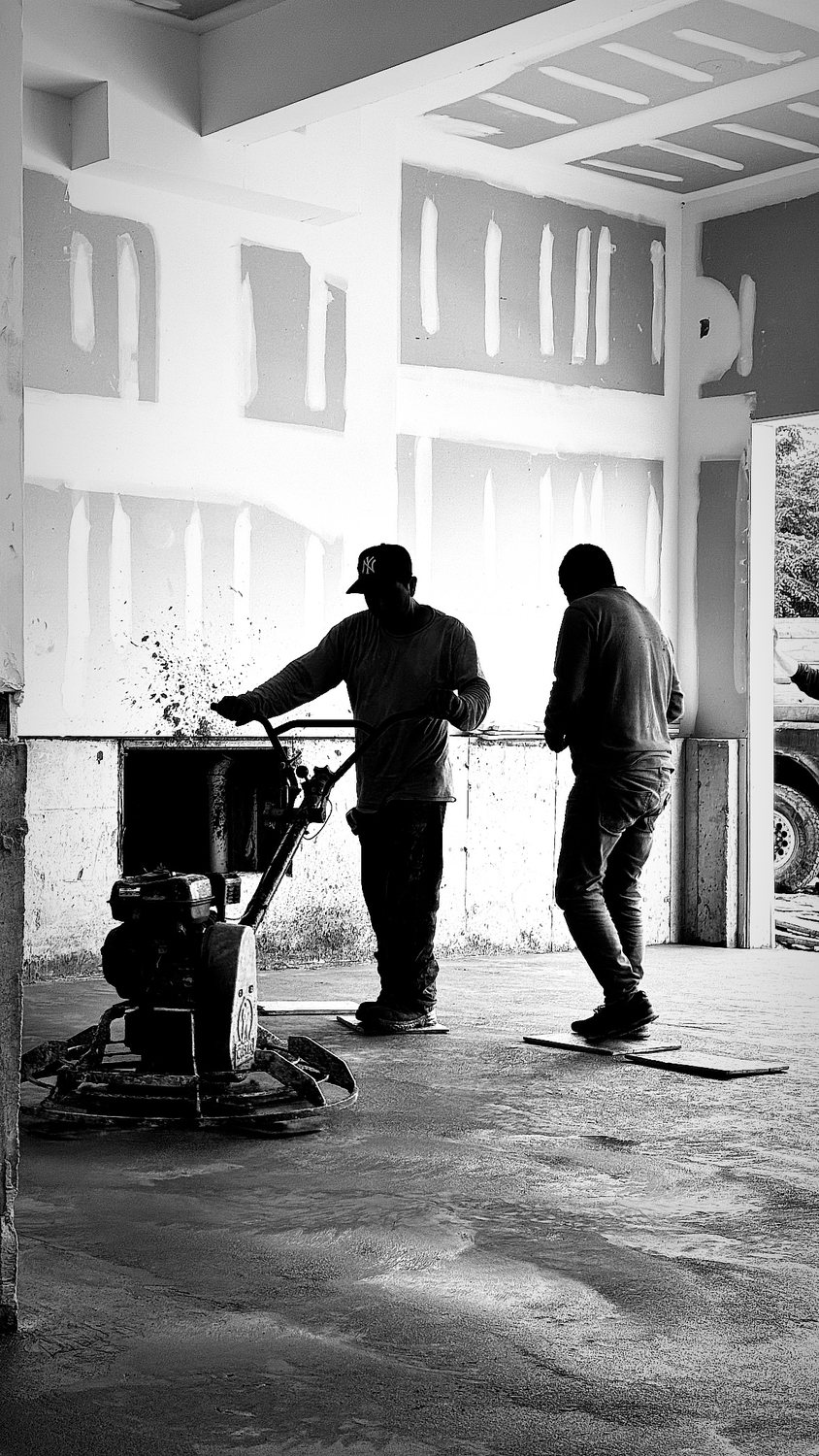 A builder at work on a More Life home, black and white.