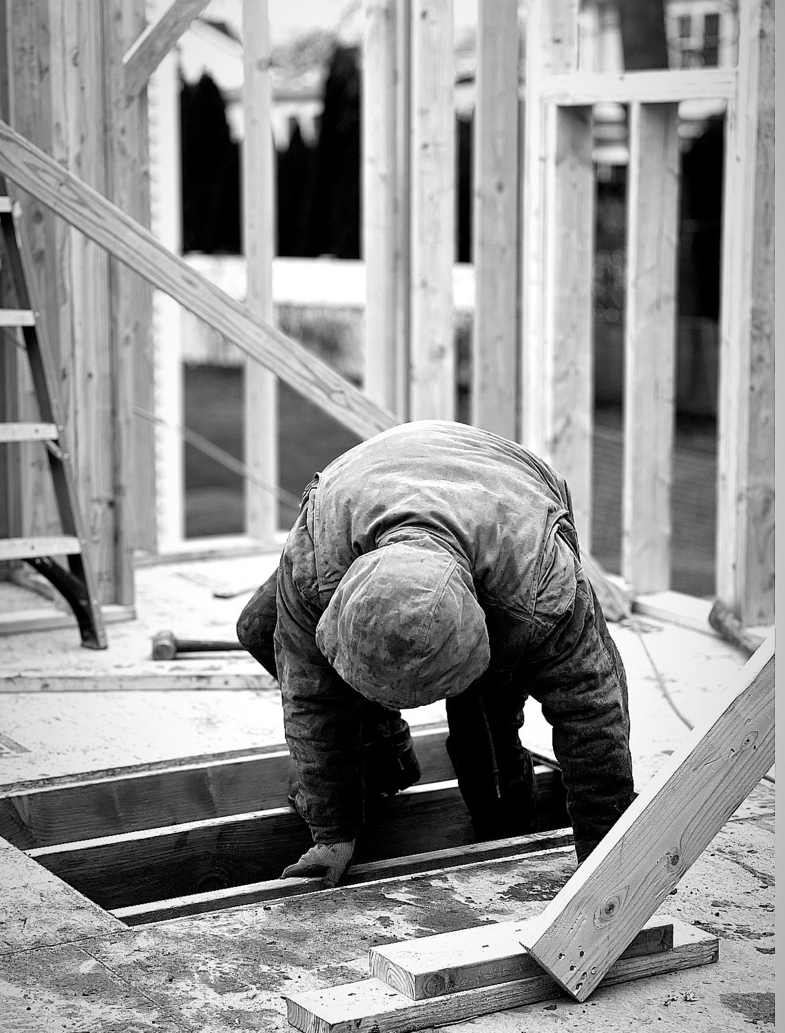 A builder at work on a More Life home, black and white.