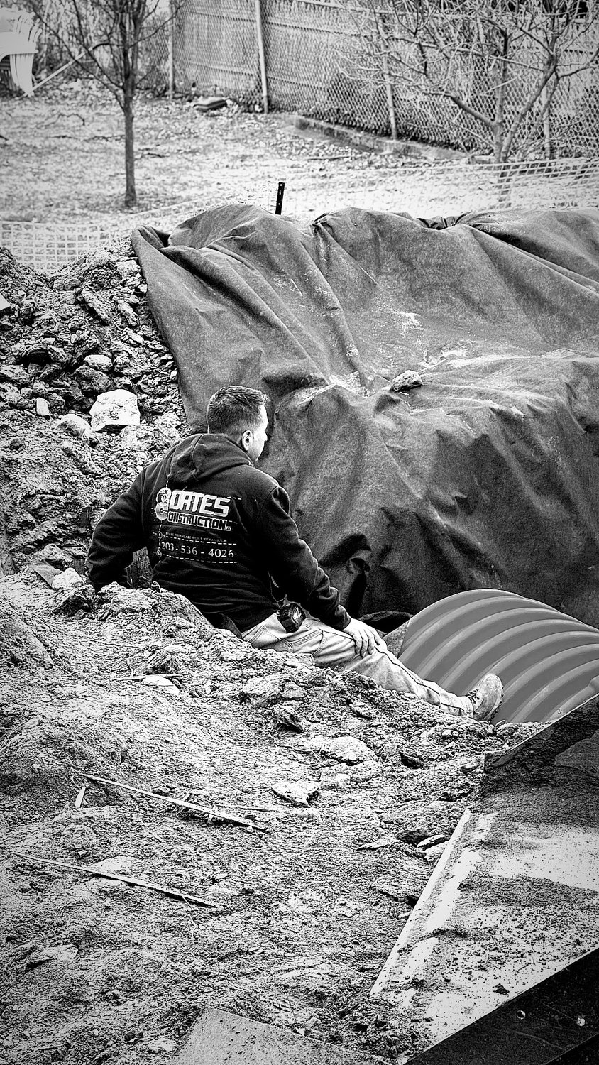 A builder at work on a More Life home, black and white.