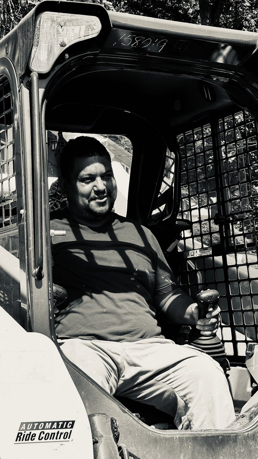 A builder at work on a More Life home, black and white.