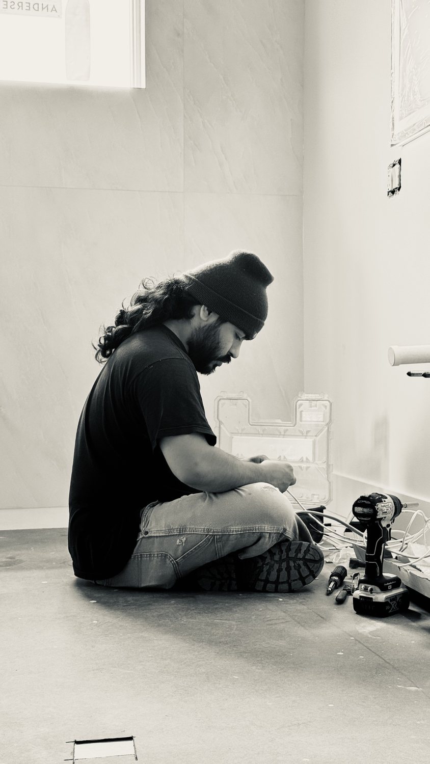 A builder at work on a More Life home, black and white.