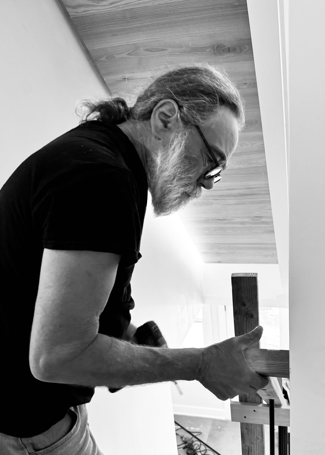 A builder at work on a More Life home, black and white.