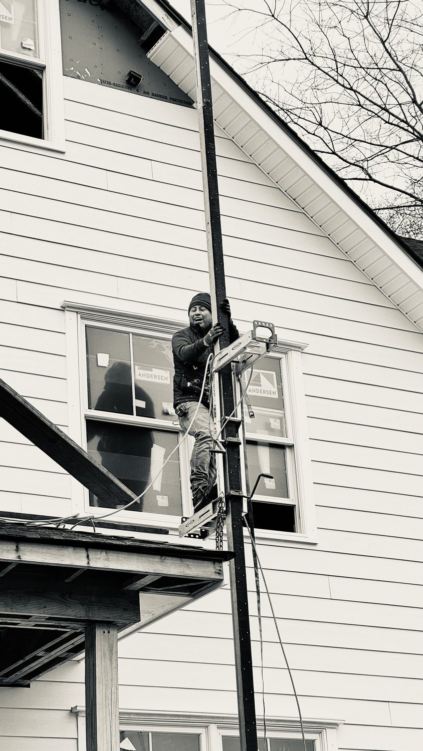 A builder at work on a More Life home, black and white.
