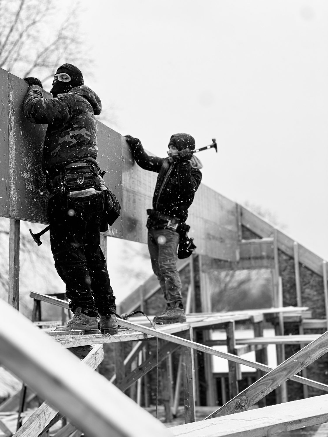 A builder at work on a More Life home, black and white.