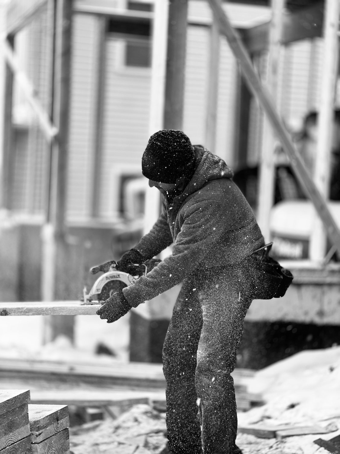 A builder at work on a More Life home, black and white.