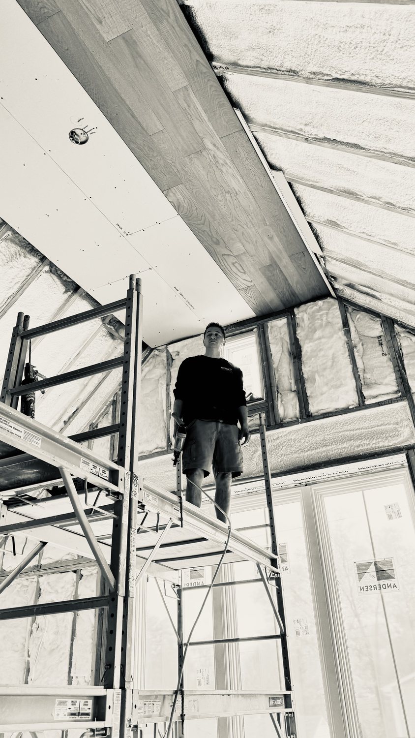 A builder at work on a More Life home, black and white.