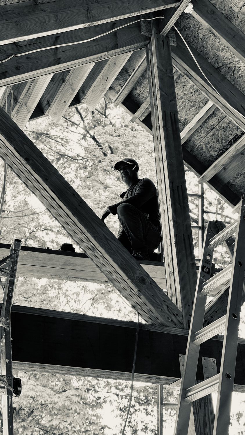 A builder at work on a More Life home, black and white.