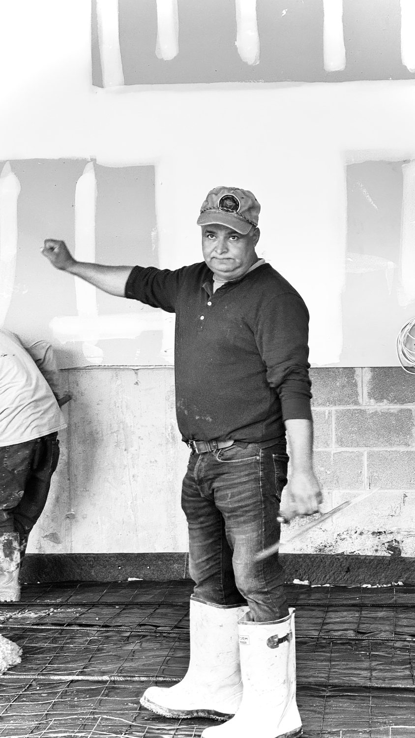 A builder at work on a More Life home, black and white.