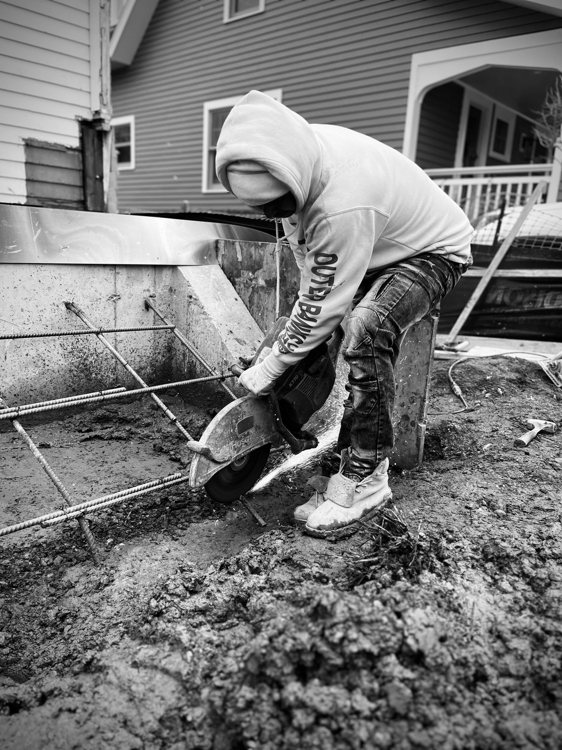 A builder at work on a More Life home, black and white.