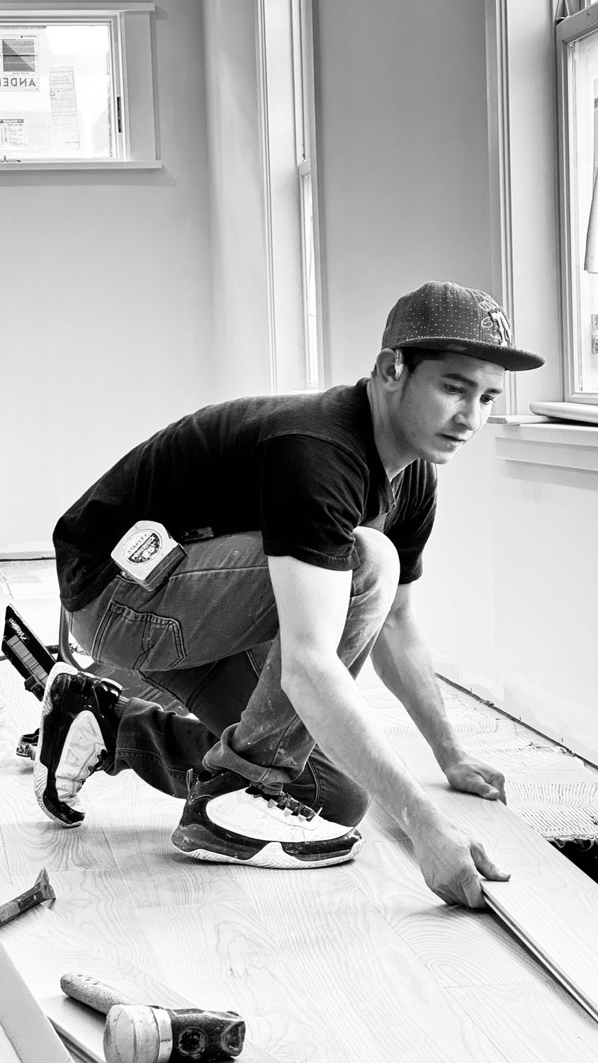 A builder at work on a More Life home, black and white.