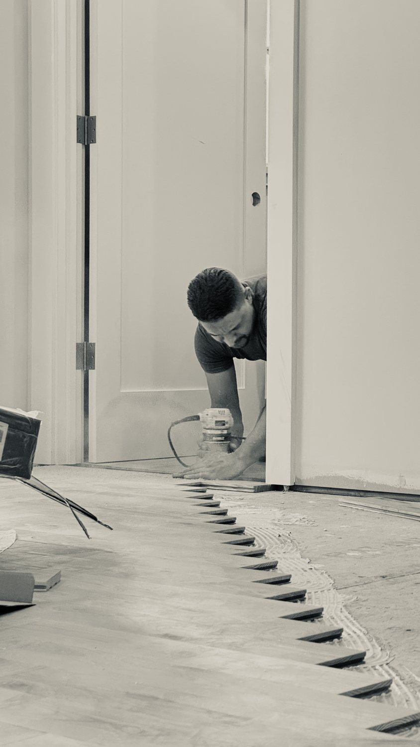 A builder at work on a More Life home, black and white.